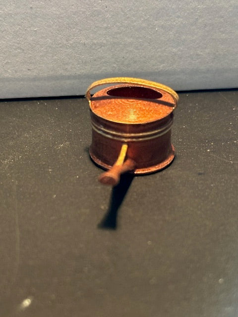 Copper coloured resin watering can