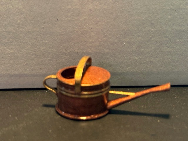 Copper coloured resin watering can