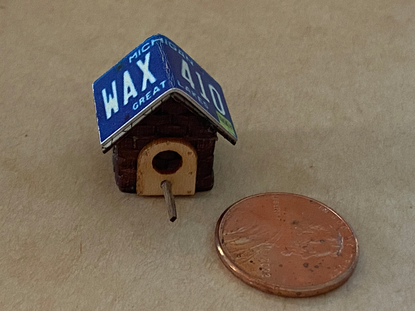 Assorted birdhouses with license plate roofs